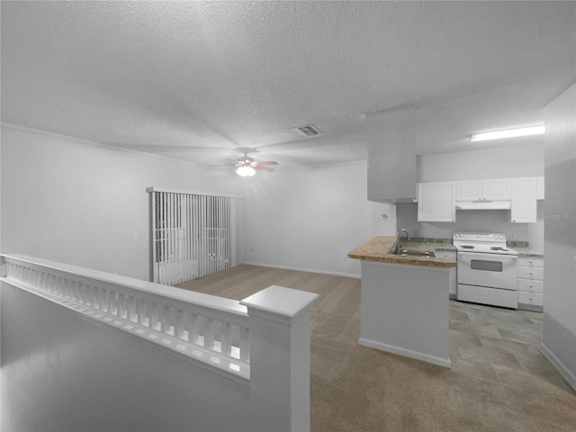 kitchen with a textured ceiling, white cabinets, white electric stove, sink, and kitchen peninsula