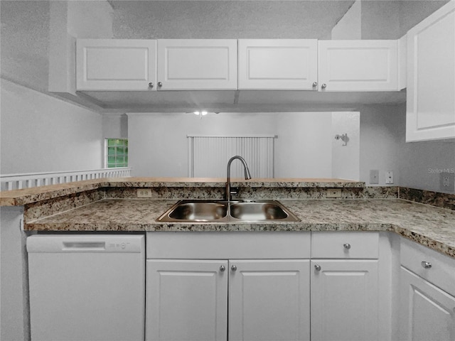 kitchen with sink, kitchen peninsula, white cabinets, and white dishwasher