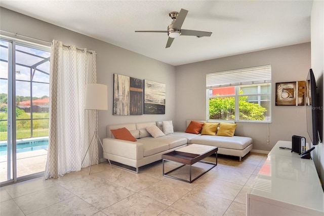 living room featuring light tile patterned flooring and ceiling fan