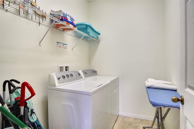 washroom with light tile patterned flooring and washing machine and clothes dryer