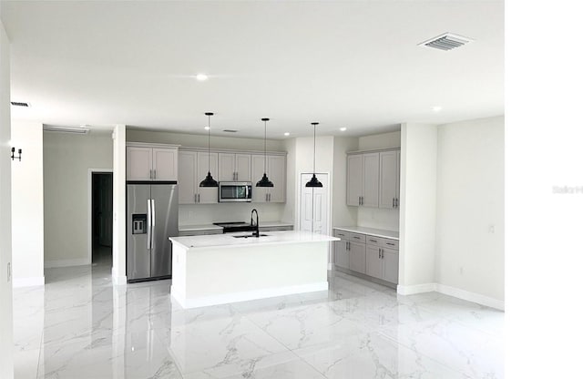 kitchen featuring a sink, stainless steel appliances, gray cabinets, and marble finish floor