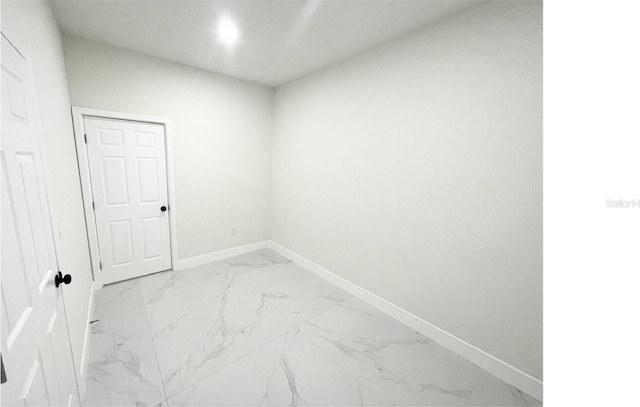 empty room with marble finish floor and baseboards