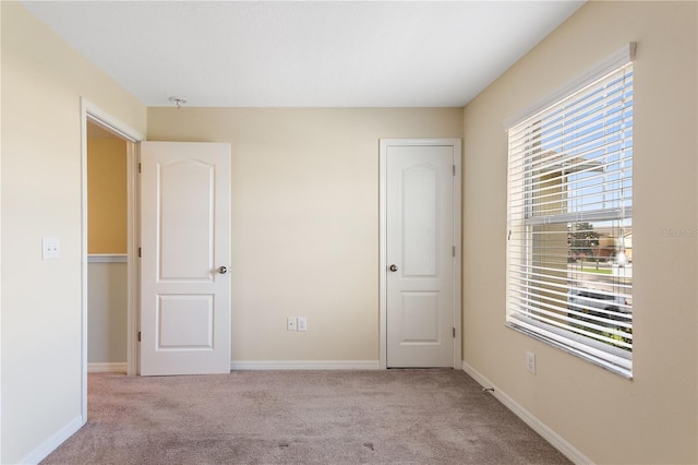 unfurnished bedroom with light carpet