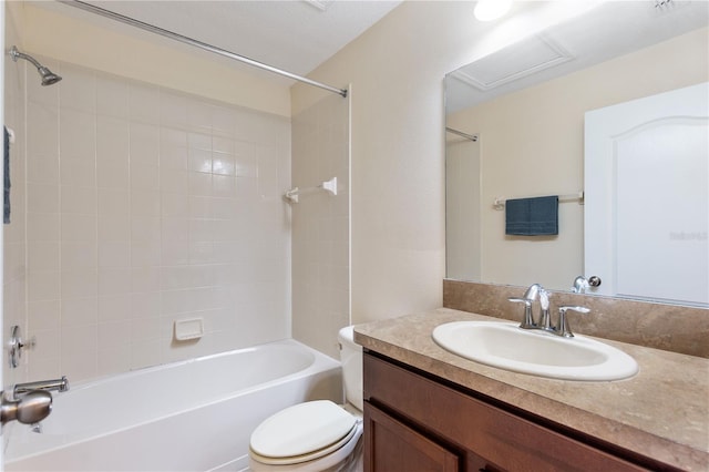 full bathroom featuring vanity, tiled shower / bath combo, and toilet