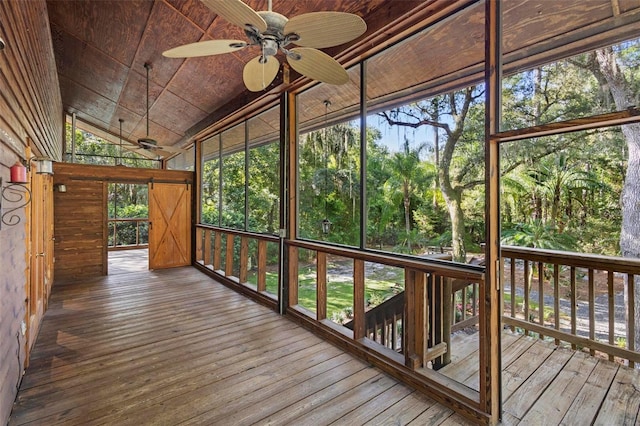 unfurnished sunroom with ceiling fan and vaulted ceiling