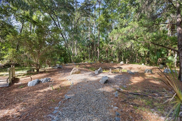 view of yard with a view of trees