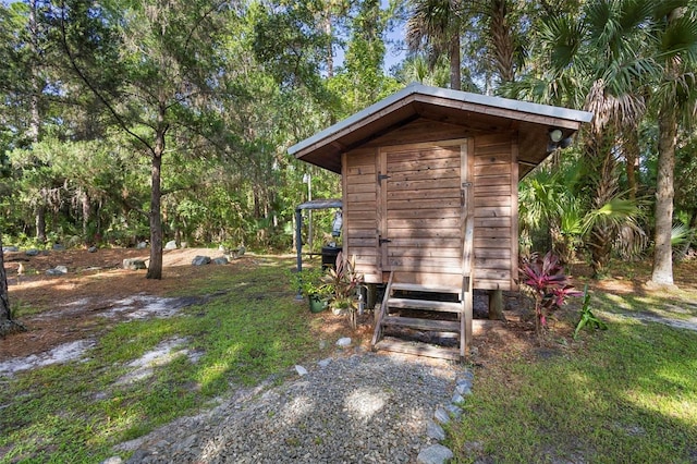 view of side of property featuring a storage unit and an outbuilding