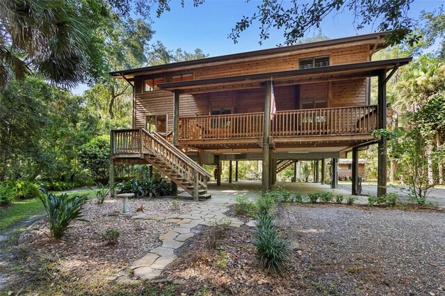 back of house featuring a deck