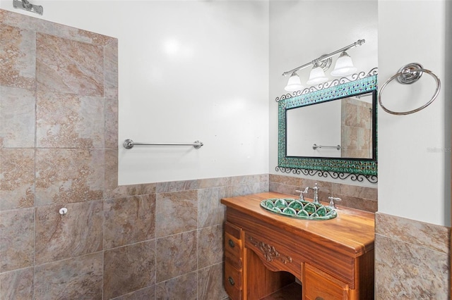 bathroom featuring a wainscoted wall, tile walls, and vanity