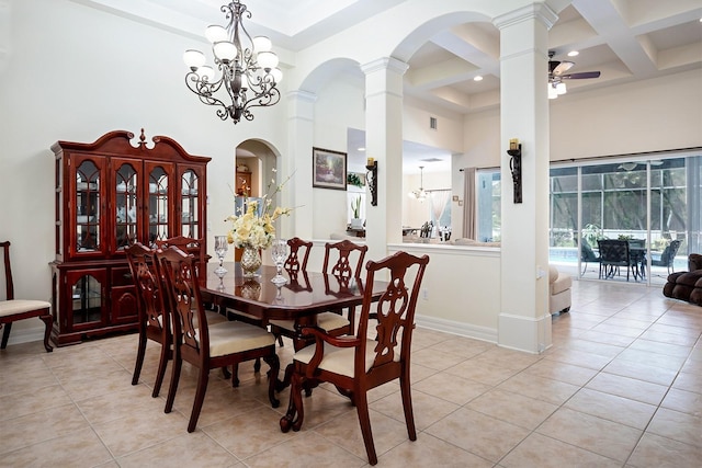 tiled dining room with a high ceiling, coffered ceiling, ceiling fan with notable chandelier, beamed ceiling, and ornate columns