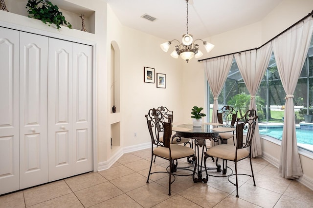 tiled dining area with an inviting chandelier