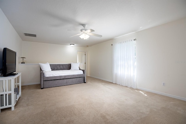 bedroom featuring light carpet and ceiling fan