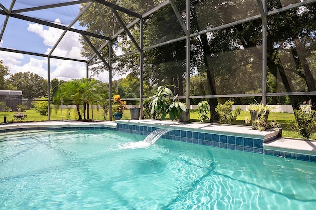 view of pool with a lanai and pool water feature