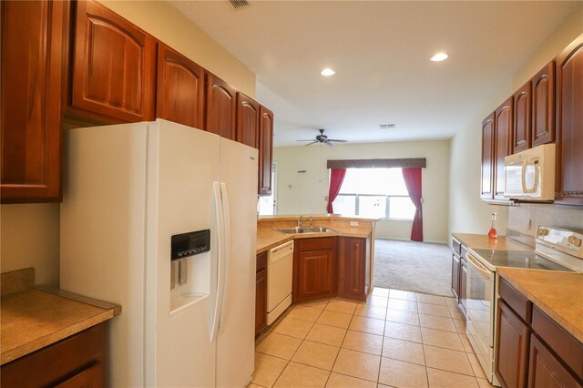 kitchen featuring white appliances, sink, kitchen peninsula, light tile patterned floors, and ceiling fan