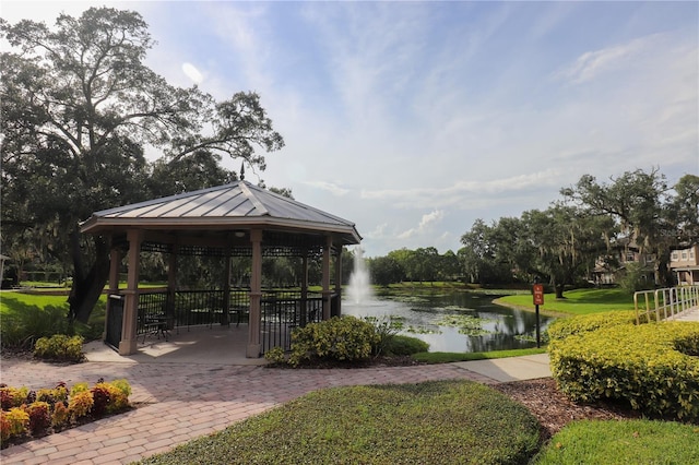 view of community with a yard, a gazebo, and a water view