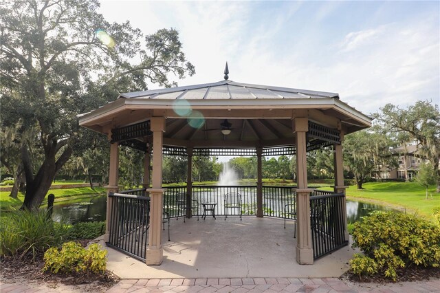 surrounding community featuring a gazebo and a water view