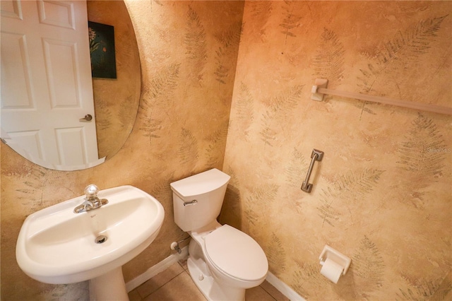 bathroom with tile patterned floors, toilet, and sink