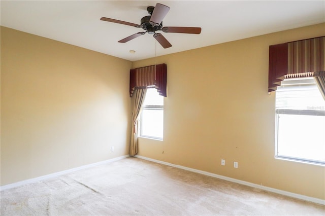 spare room with light carpet and ceiling fan