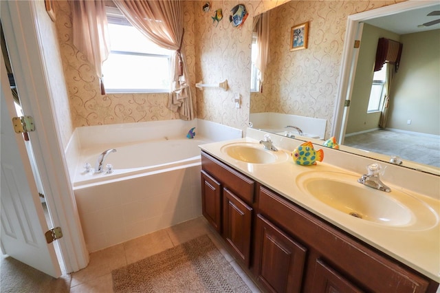 bathroom with vanity, tiled bath, and tile patterned flooring