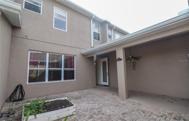 exterior space with ceiling fan