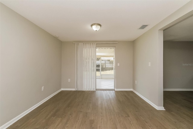 unfurnished room featuring hardwood / wood-style flooring