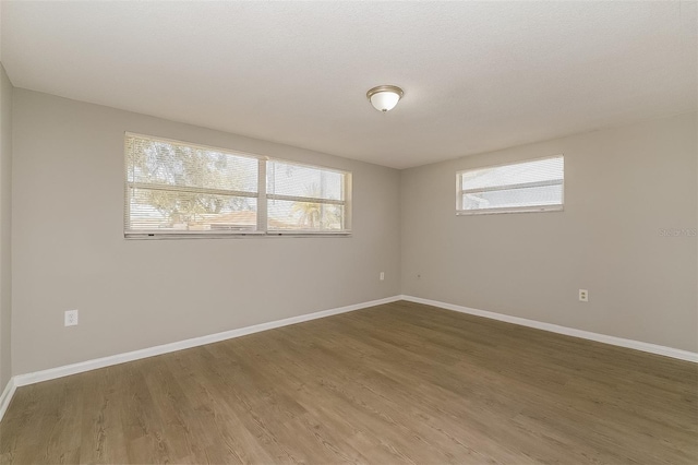 empty room with hardwood / wood-style floors