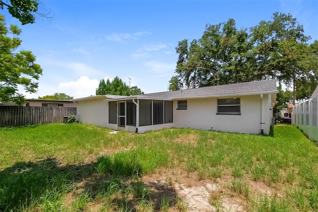 back of house featuring a lawn