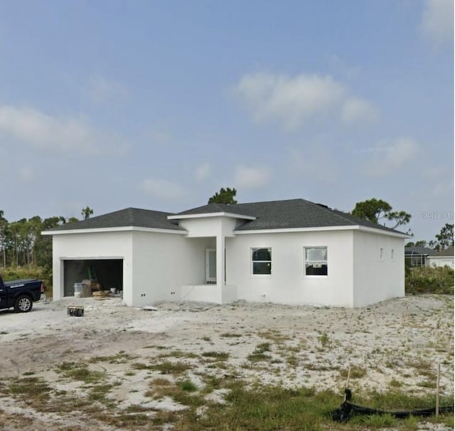 rear view of house with a garage