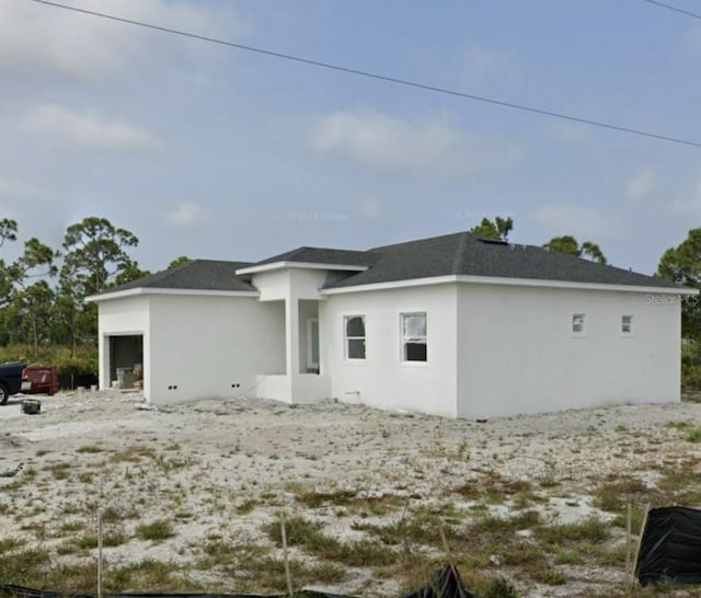 rear view of house with a garage