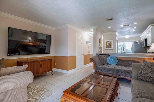 tiled living room featuring sink, crown molding, and a textured ceiling