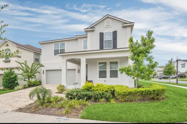 view of front of property with a garage and a front lawn