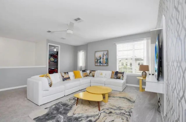 carpeted living room with ceiling fan