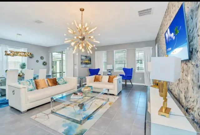 tiled living room with a notable chandelier and plenty of natural light