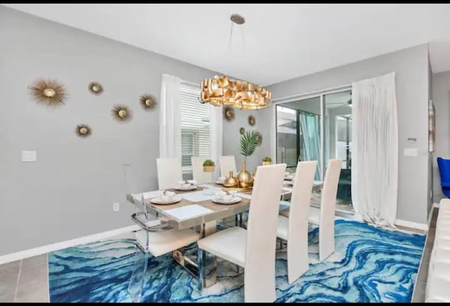 tiled dining space with an inviting chandelier