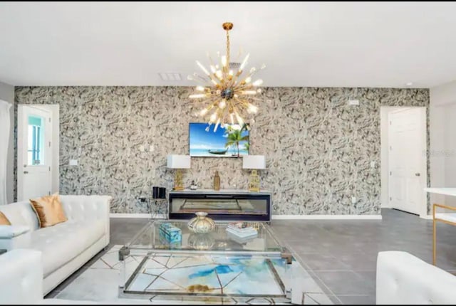 tiled living room with a notable chandelier