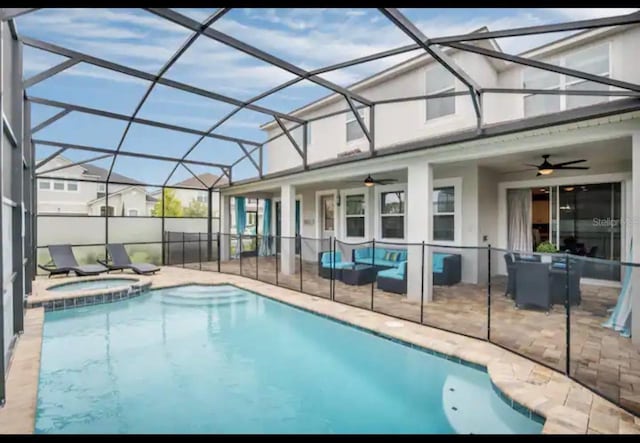 view of pool with an in ground hot tub, a patio, a lanai, and ceiling fan