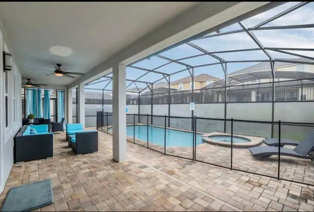 view of swimming pool with an in ground hot tub, a patio, a lanai, and ceiling fan