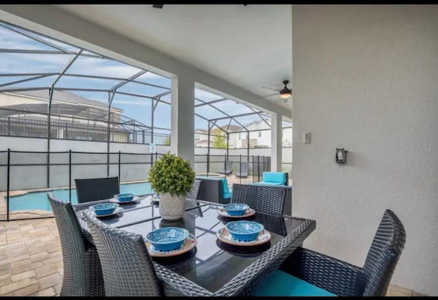 sunroom / solarium featuring ceiling fan