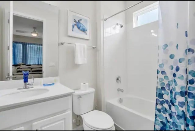 full bathroom with vanity, shower / tub combo, ceiling fan, and toilet