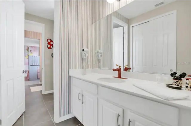 bathroom with tile patterned floors and vanity