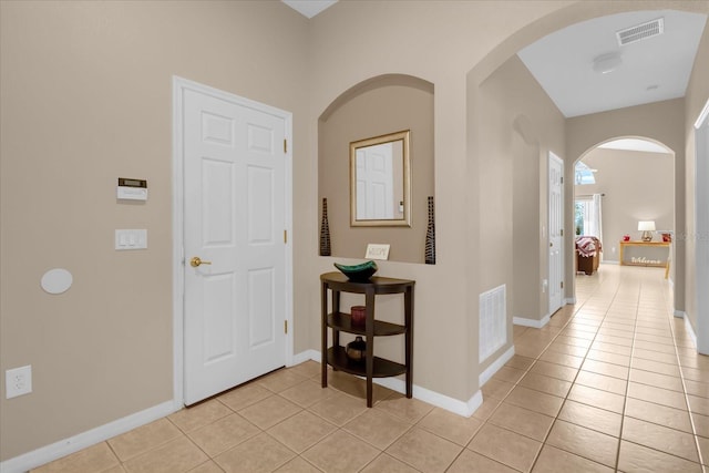 corridor featuring light tile patterned flooring