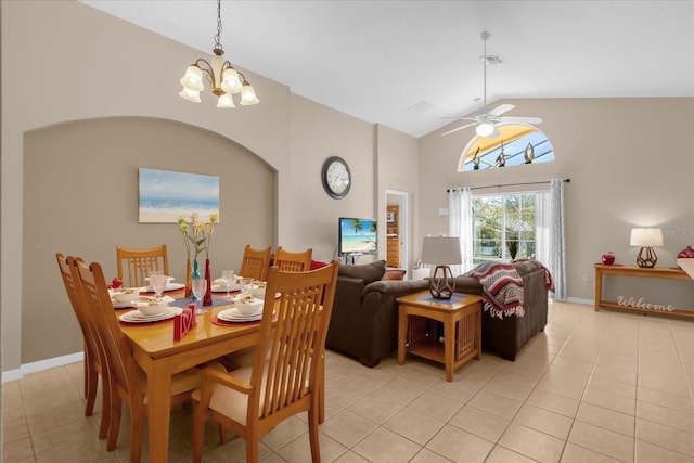 tiled dining area featuring ceiling fan with notable chandelier and vaulted ceiling