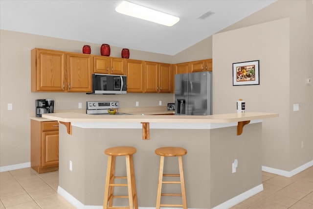 kitchen with a breakfast bar, a center island, and stainless steel appliances