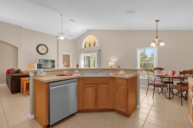 kitchen featuring stainless steel dishwasher, ceiling fan with notable chandelier, a kitchen island with sink, sink, and lofted ceiling