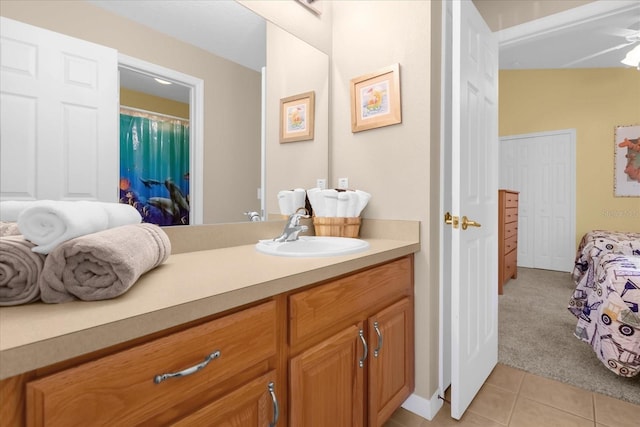 bathroom featuring tile patterned floors, ceiling fan, and vanity