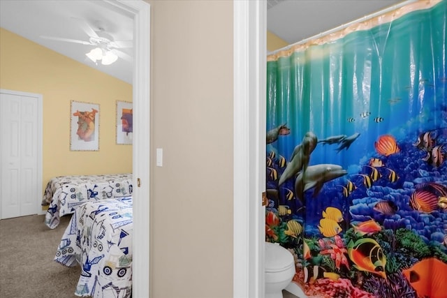 bathroom featuring toilet, vaulted ceiling, and ceiling fan