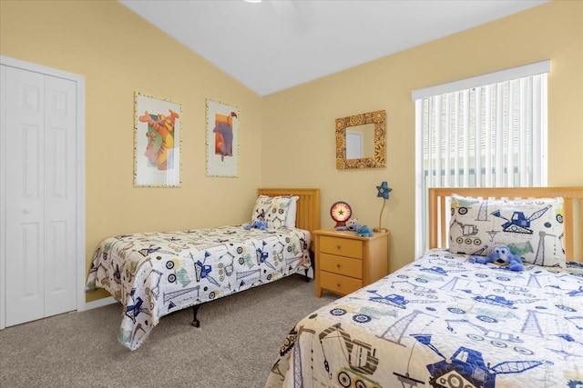 carpeted bedroom featuring ceiling fan, vaulted ceiling, and a closet