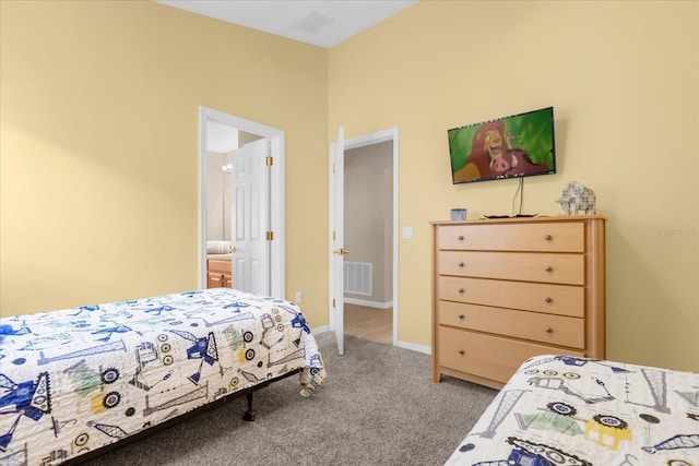 carpeted bedroom with ensuite bath