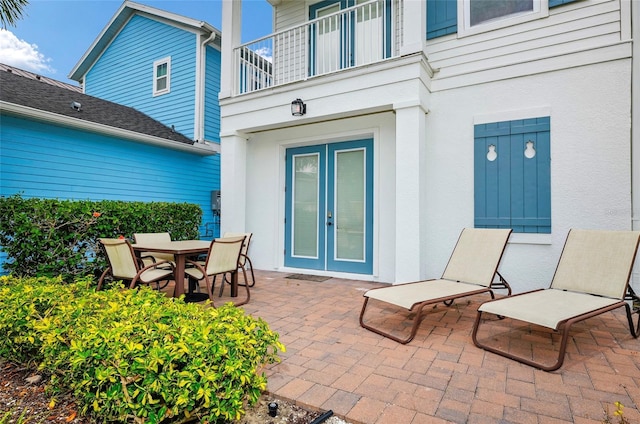 view of patio / terrace with a balcony and french doors