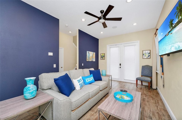 living room featuring ceiling fan and light wood-type flooring